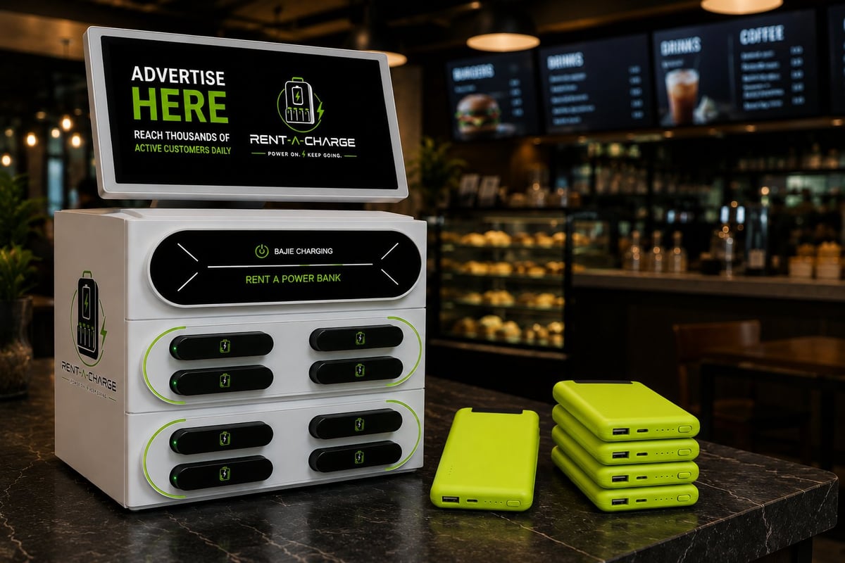 White phone charging station with advertise here display on counter next to stacked neon yellow phone cases in modern cafe